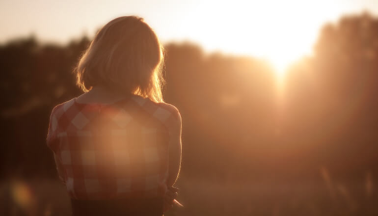 woman looking at sunset