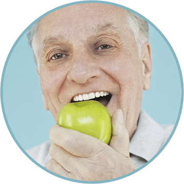 Elder man eating a green apple