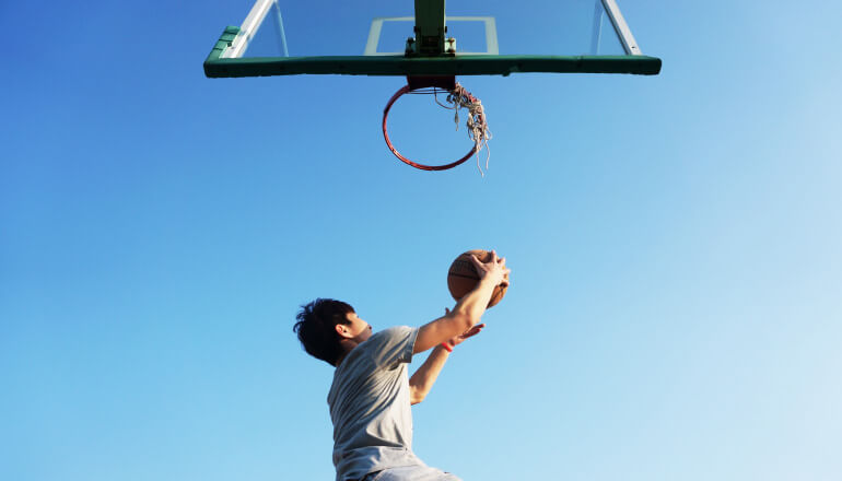 kid playing basketball wearing mouthguard