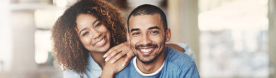 Curly-haired woman leaning on man smiling
