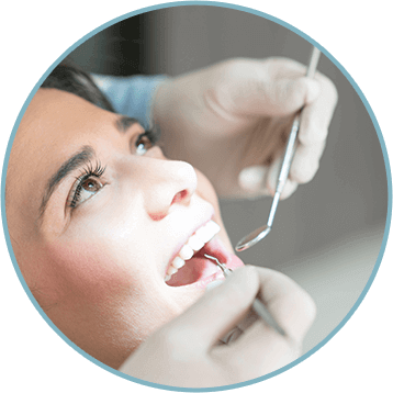 woman having her teeth examined by her dentist