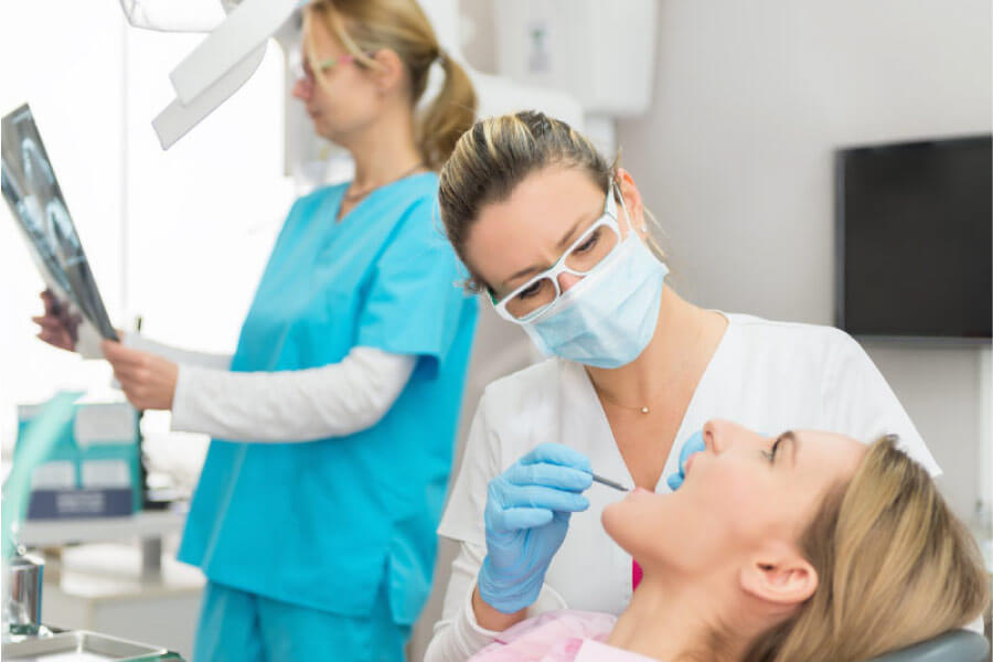 woman get endodontics treatment at the dentist
