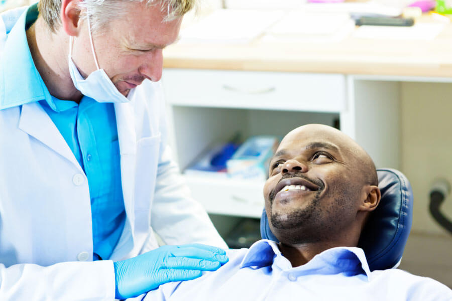 man gets a gum exam from the dentist