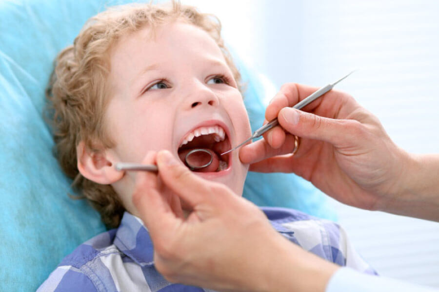 young boy receiving a dental exam