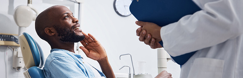 man talking with his dentist